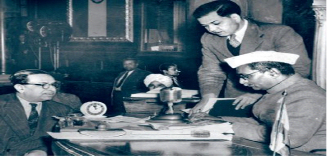 Dr. Rajendra Prasad signing a copy of the new Constitution of the Indian Republic
